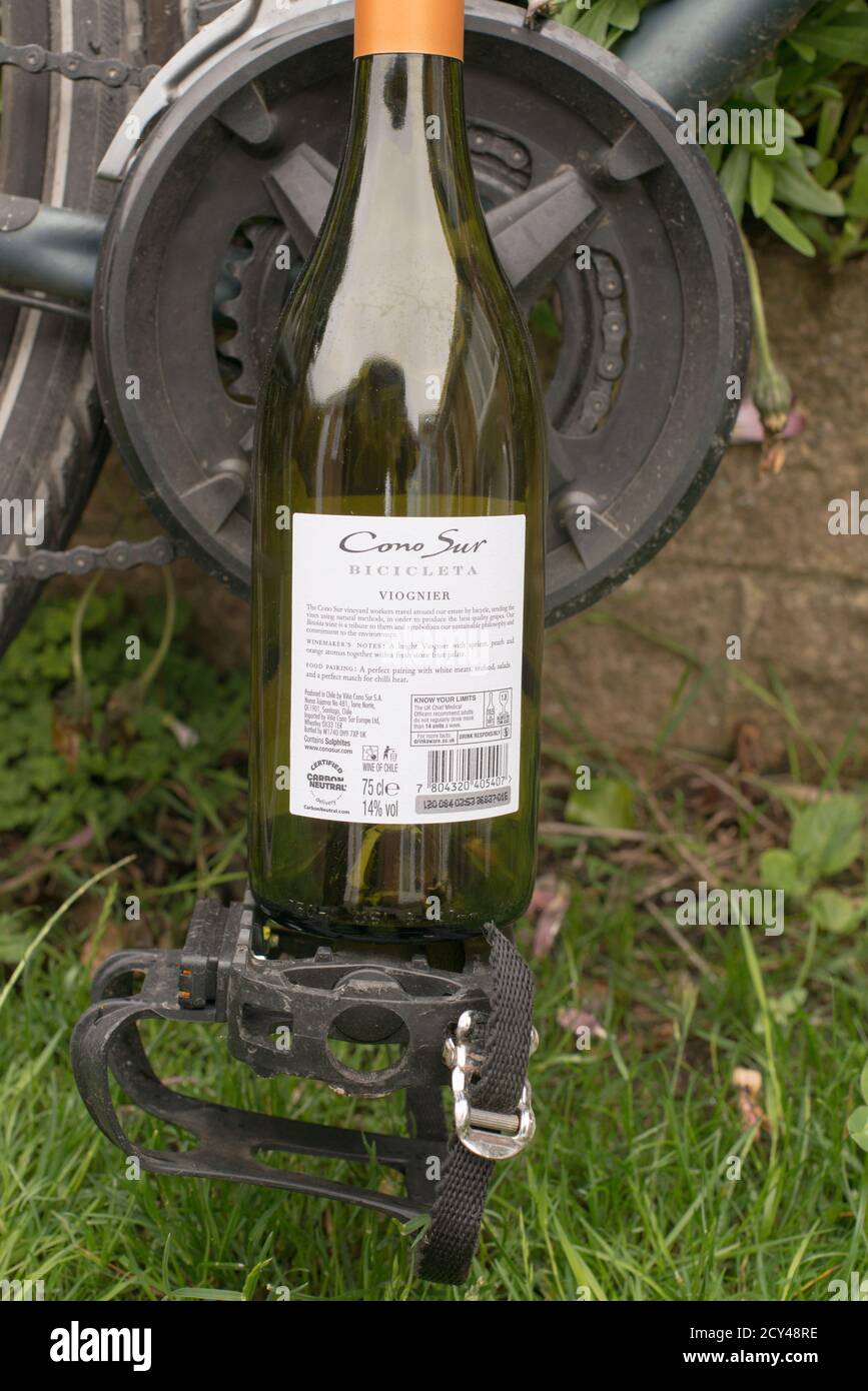 Wine bottle with lable celebrating the use of bicycles in the winemakers vineyard, reducing its carbon footprint. Stock Photo