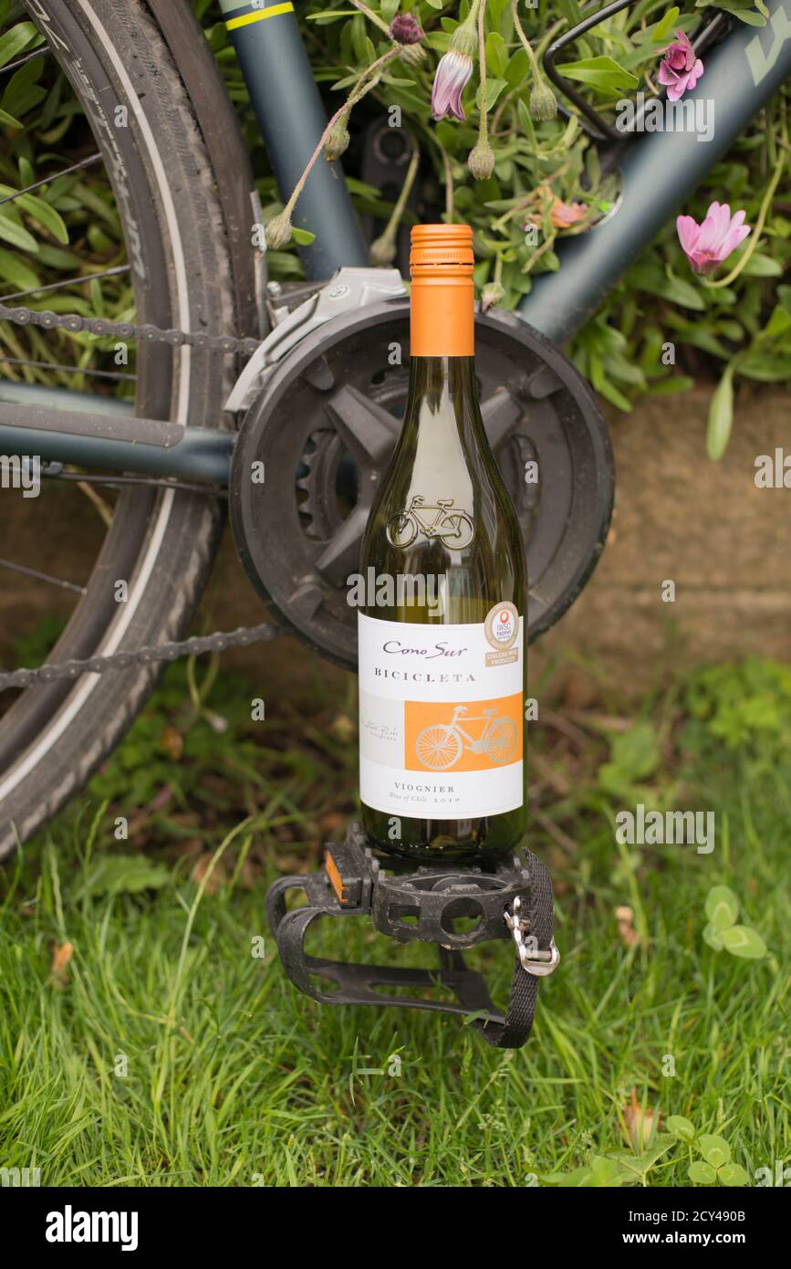 Wine bottle with lable celebrating the use of bicycles in the winemakers vineyard, reducing its carbon footprint. Stock Photo