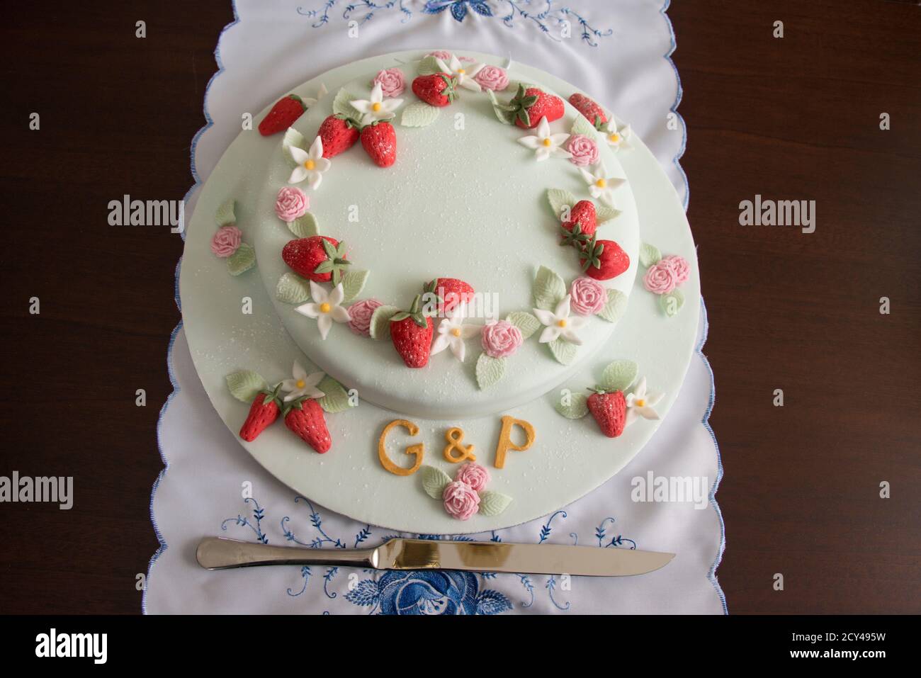 Joint birthday cake with initials G & P, iced with summer fruits and flowers Stock Photo