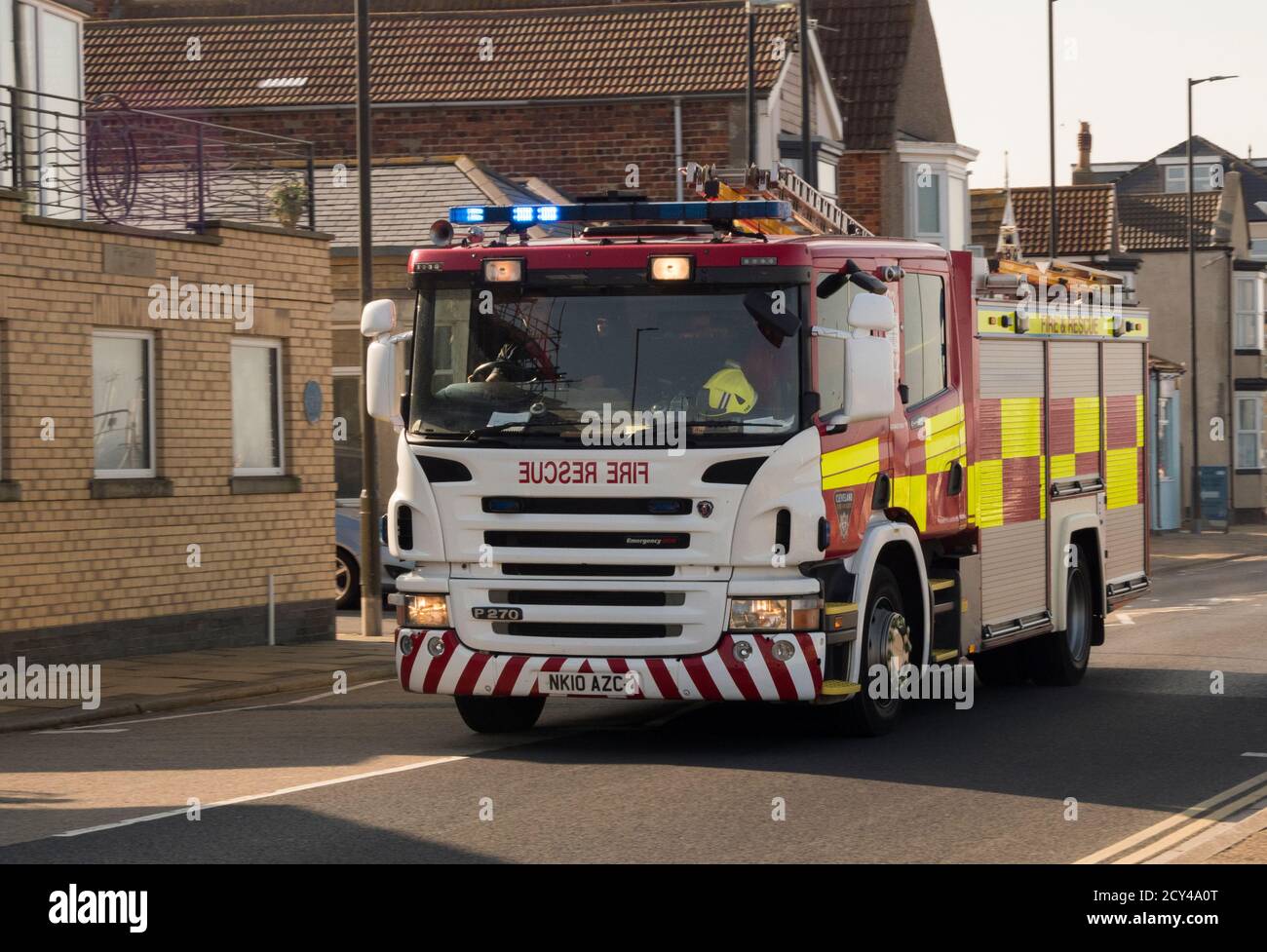 Fire engine on call out speeding along sea front in Redcar Cleveland Stock Photo