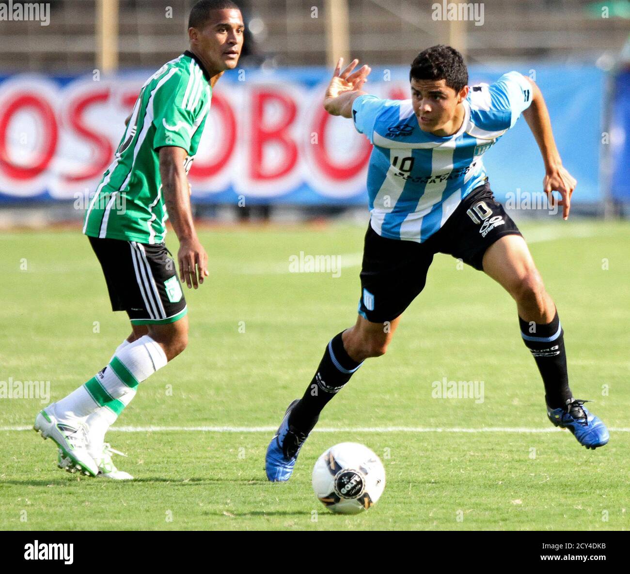 Giovanni Moreno (R) of Argentina's Racing Club runs past Macnelli Torres of  Colombia's Atletico Nacional during their friendly football match at  Atanasio Girardot stadium in Medellin January 30, 2011. REUTERS/ Albeiro  Lopera (
