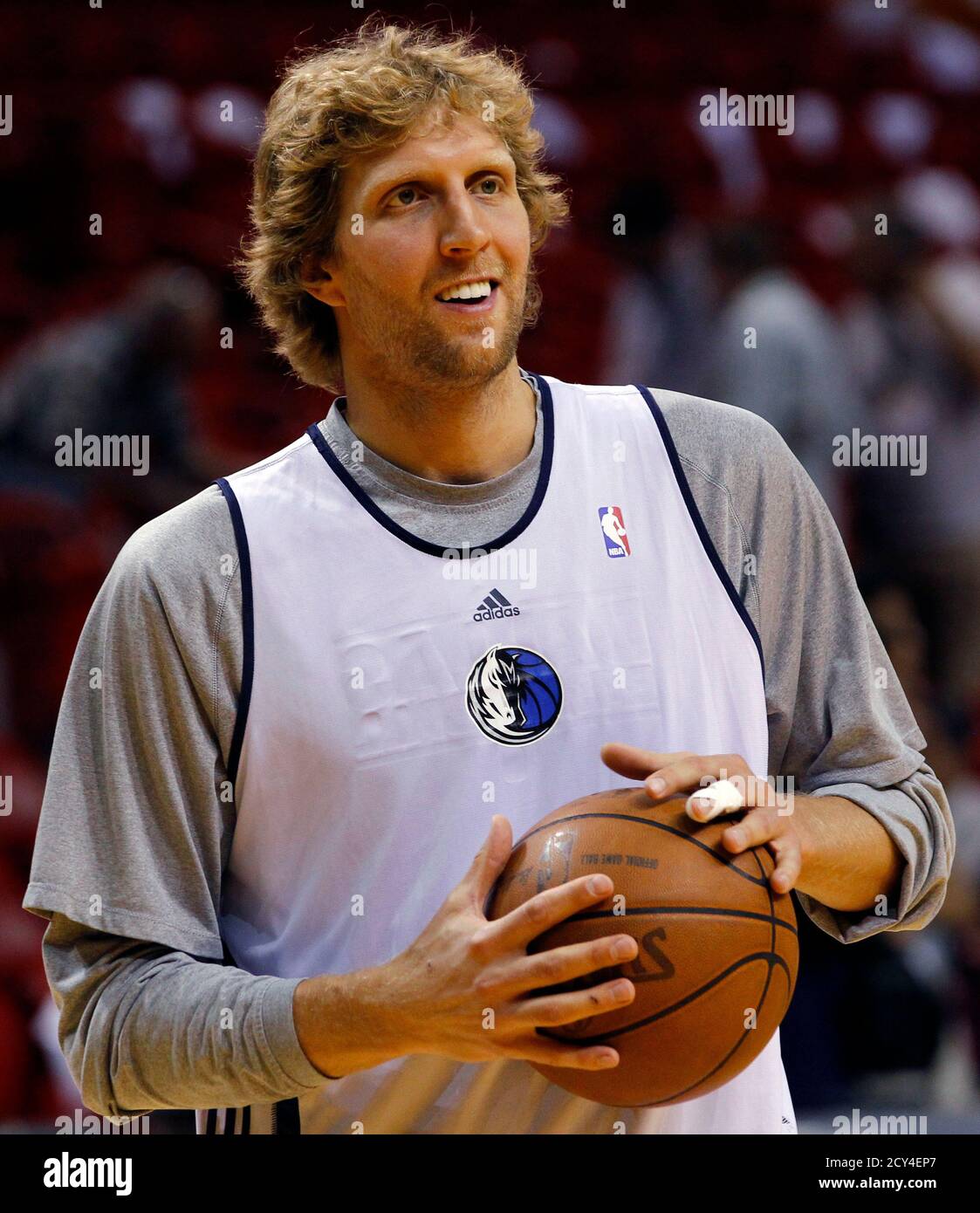 Dallas Mavericks' Dirk Nowitzki holds a ball during a team practice at the  NBA Finals basketball series in Miami, June 1, 2011. Nowitzki tore tendons  in his left middle finger on a