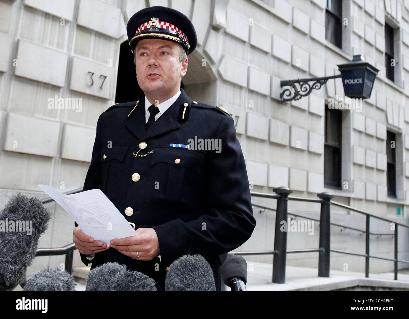 City of London Police Commander Ian Dyson reads a statement outside Wood  Street Police Station in London September 15, 2011. Swiss bank UBS said a  rogue trader had lost $2 billion in