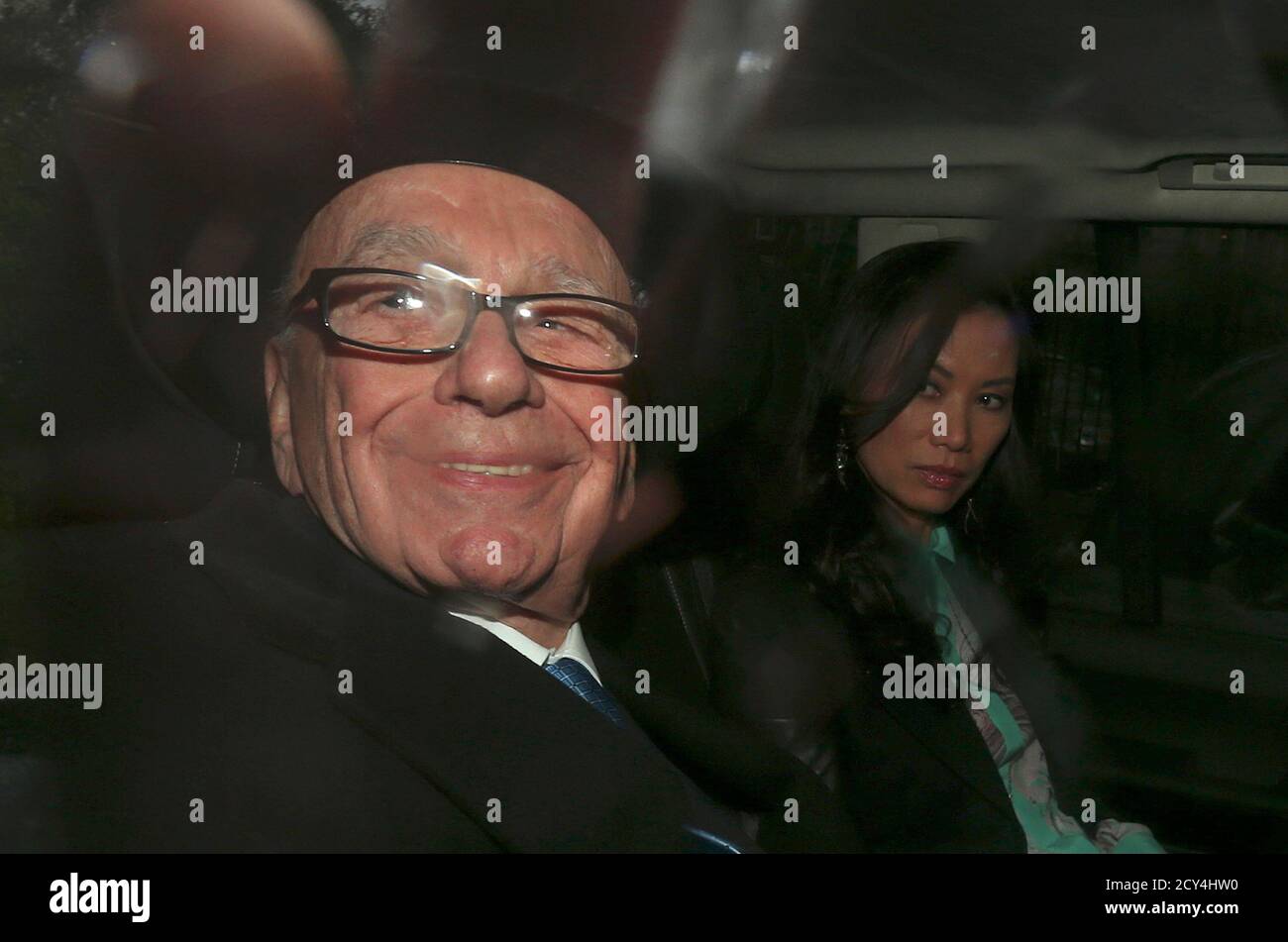 Rupert Murdoch, with his wife Wendi, is driven away after giving evidence to the Leveson Inquiry in the High Court in central London April 25, 2012. Murdoch rejected accusations on Wednesday that he used his media empire to play puppet master to a succession of British prime ministers, electrifying a media inquiry that has shaken the government and unnerved much of the establishment.     REUTERS/Suzanne Plunkett   (BRITAIN - Tags: ENTERTAINMENT MEDIA BUSINESS CRIME LAW POLITICS SOCIETY) Stock Photo