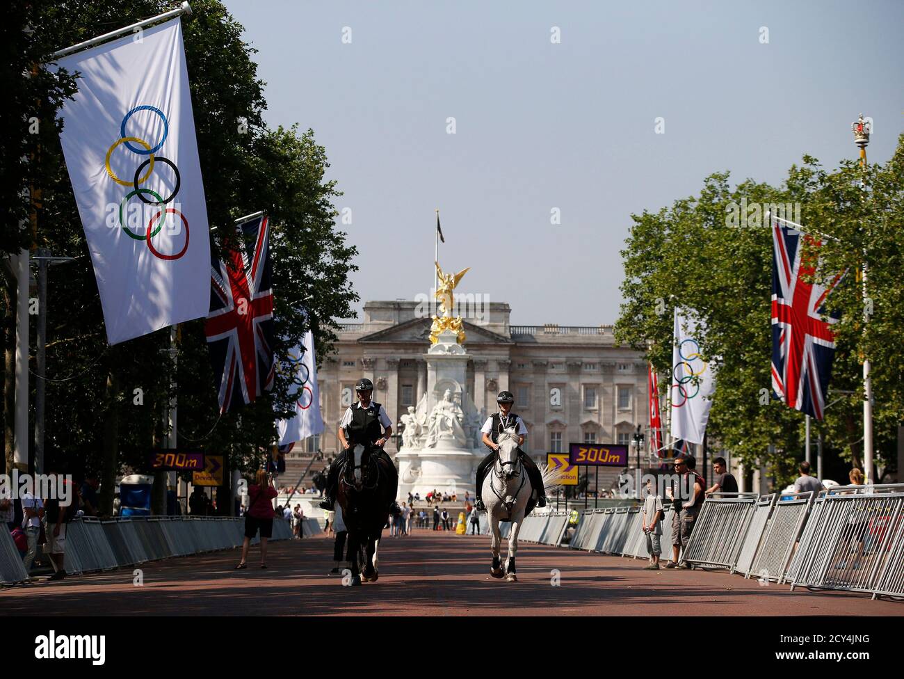 Mounted police patrol in front of Buckingam Palace down The Mall which will serve as the start and finish area for the road cycling race event at the London 2012 Olympic Games July 26, 2012.  REUTERS/Paul Hanna  (BRITAIN - Tags: SPORT OLYMPICS CYCLING) Stock Photo