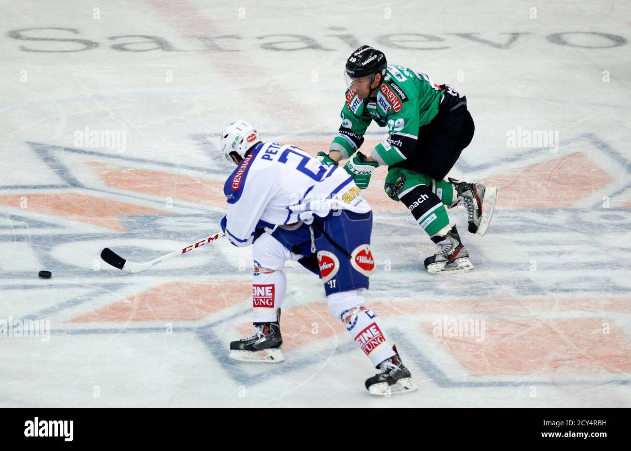 Telemach Olimpija player Anze Ropret (R) challenges VSV Villach's Benjamin Petrik during their EBEL league in Sarajevo January 10, 2014. Austria's Ice Hockey league, known as Erste Bank Eishockey Liga (EBEL), groups hockey teams from Austria, Slovenia, Hungary, the Czech Republic and Italy. The league will have its first match in Sarajevo on January 10 to mark the 30th anniversary of the 14th Winter Olympic Games hosted by the Bosnian capital. REUTERS/Dado Ruvic (BOSNIA AND HERZEGOVINA - Tags: SPORT ICE HOCKEY) Stock Photo