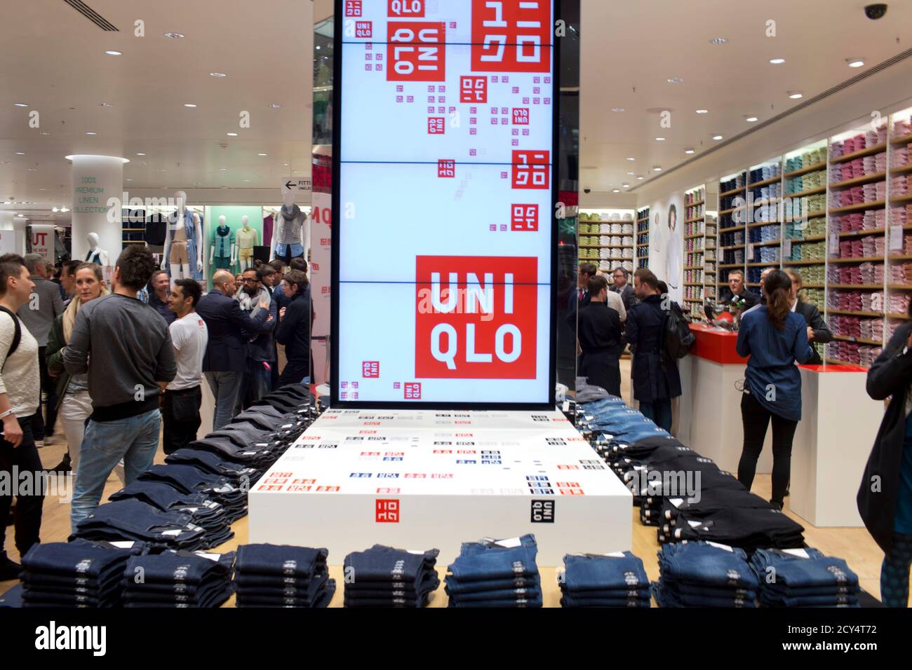 People visit the Uniqlo Global flagship store during a preopening in  Berlin, April 10, 2014. Japanese casual wear chain Uniqlo opens its first  store in Germany on Friday, as it accelerates expansion