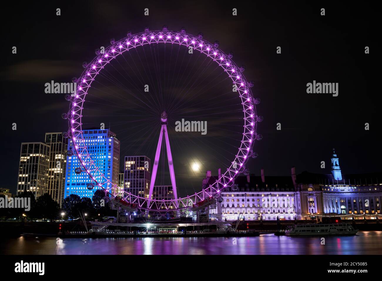 A harvest moon rises behind the London Eye Stock Photo - Alamy