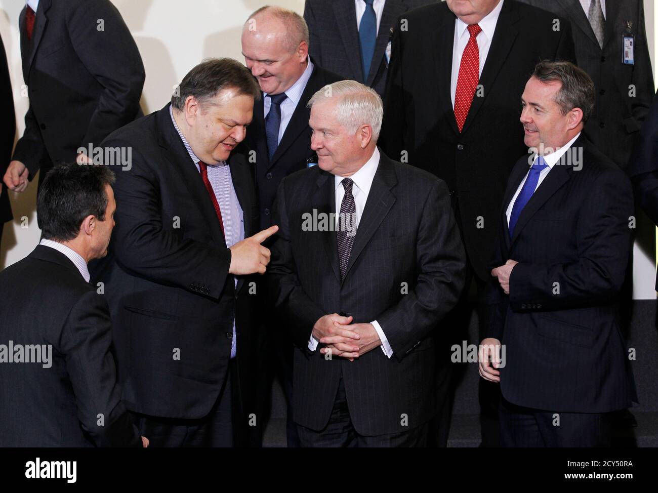 NATO Secretary-General Anders Fogh Rasmussen (L), Greece's Defence Minister Evangelos Venizelos (2nd L), U.S. Defense Secretary Robert Gates (2nd R) and Britain's Defence Secretary Liam Fox (R) talk during a family photo following a NATO defence ministers meeting at the Alliance headquarters in Brussels March 10, 2011. NATO defence ministers meeting in Brussels on Thursday and Friday will discuss options to respond to the turmoil in Libya, including a possible no-fly zone, the officials said.    REUTERS/Thierry Roge   (BELGIUM - Tags: MILITARY POLITICS CONFLICT) Stock Photo