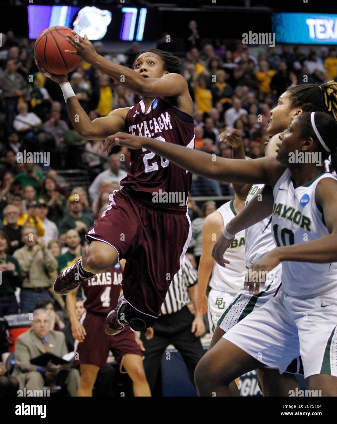 Texas A&M Aggies guard Tyra White (L) drives against Baylor Lady Bears  forward Destiny Williams in the first half of their NCAA Women's Dallas  Regional college basketball game in Texas March 29 ,