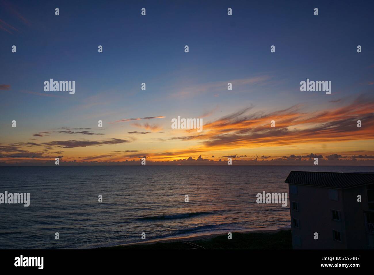 A colorful blue, yellow, and orange sunrise over the Atlantic Ocean on ...