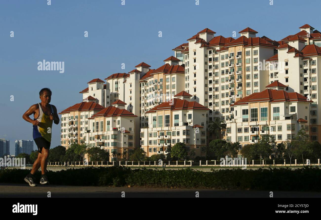 A Man Jogs Past Blocks Of Private Condominium At Tanjong Rhu In Singapore March 15 2013