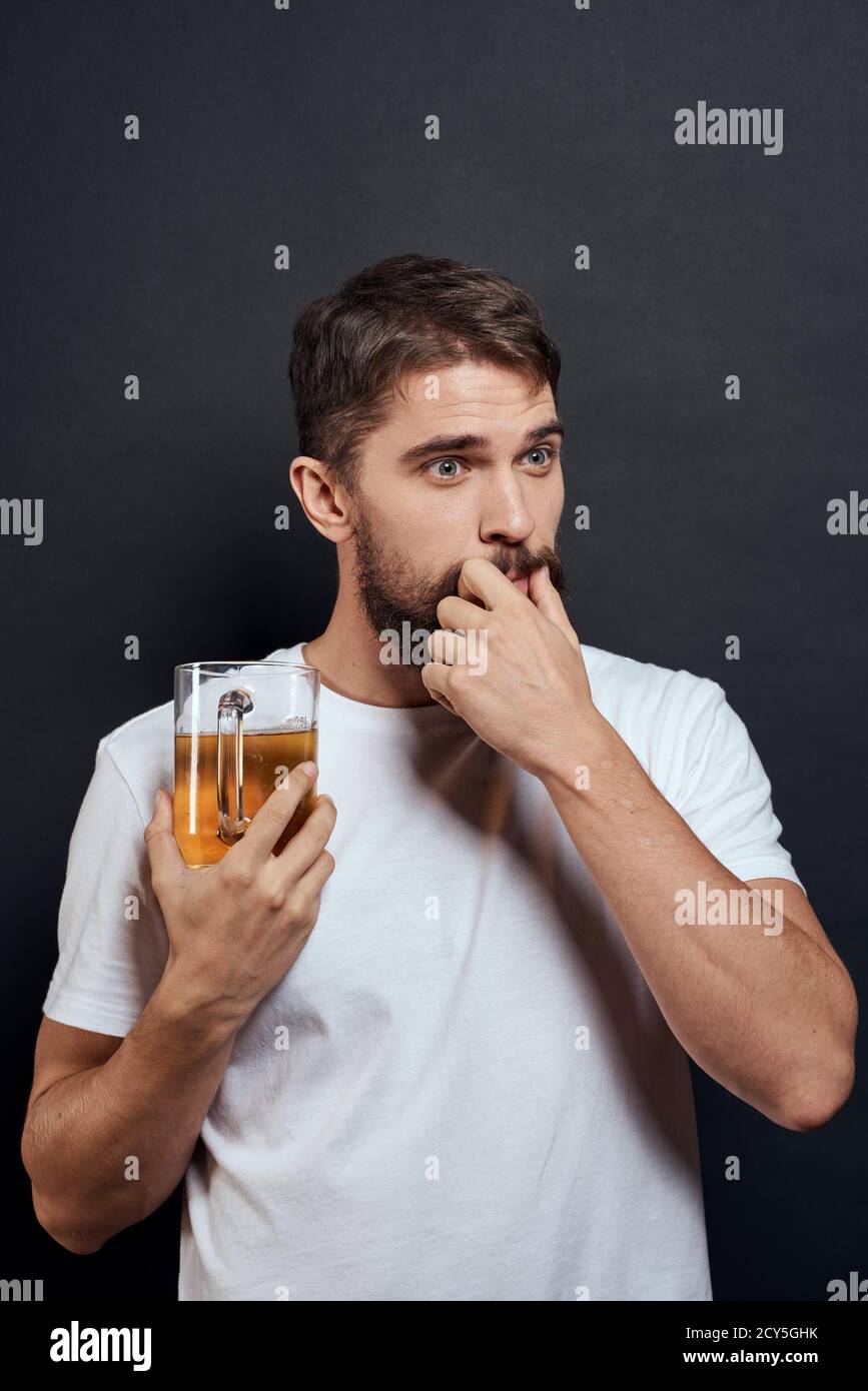 man with a mug of beer in a white tshirt emotions lifestyle drunk on a