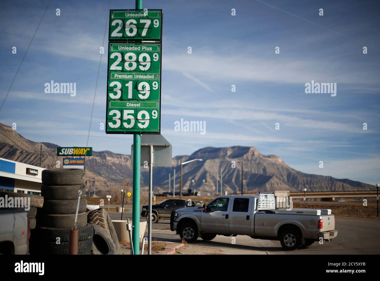 Gas prices in Parachute, Colorado, December 10, 2014. The economy of Parachute, with a current population of approximately 1000 people, was devastated when thousands of workers lost their jobs on 'Black Sunday' in 1982, after Exxon terminated the Colony Shale Oil Project. The current rise of hydraulic fracking in natural gas retrieval has given a cautious hope to the town's inhabitants, who know that market demand brings both boom and bust. Picture taken December 10, 2014.     REUTERS/Jim Urquhart (UNITED STATES  - Tags: ENERGY BUSINESS) Stock Photo
