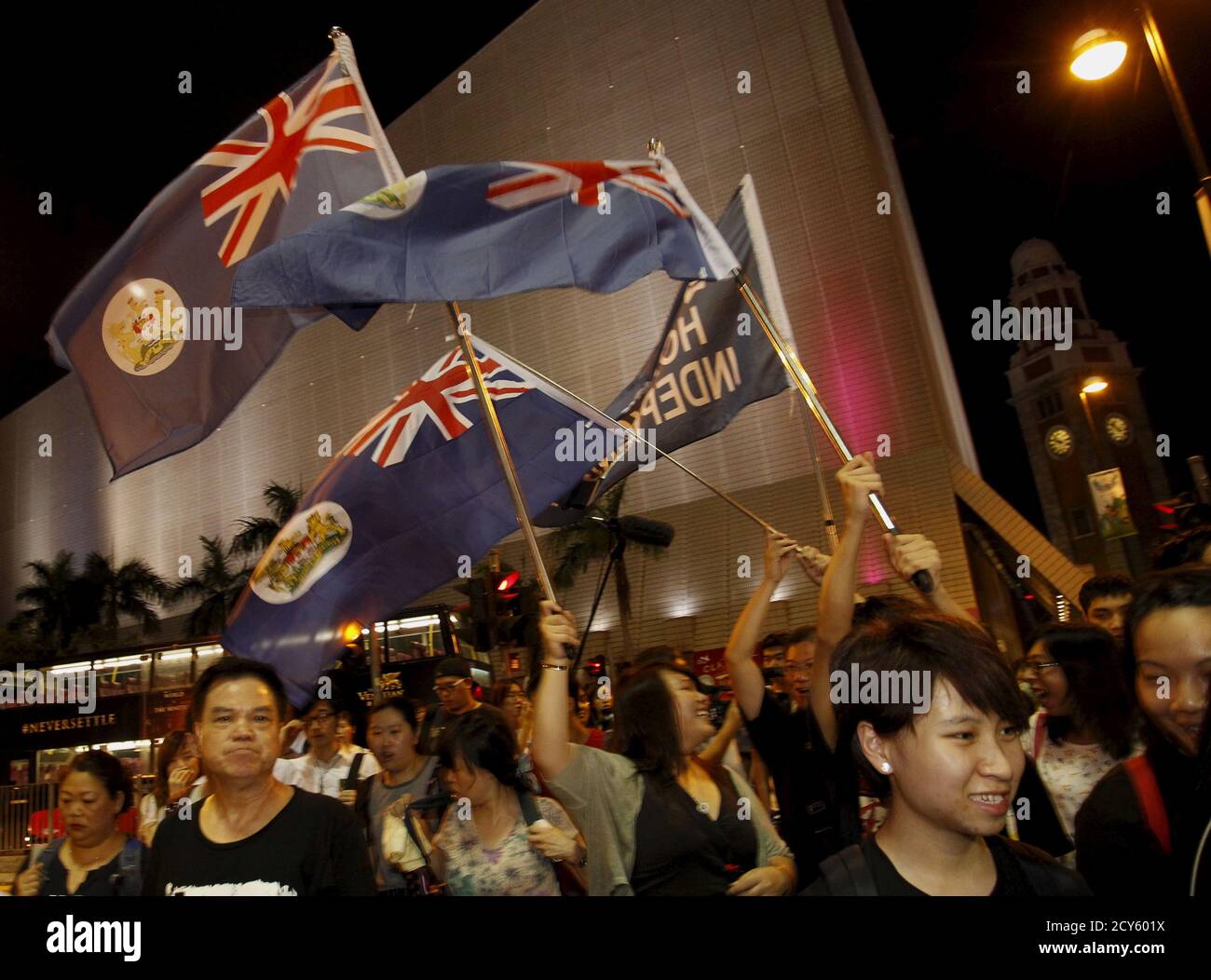 Protesters carrying former colonial Hong Kong flags take to the streets after a rally to mark the 1989 Tiananmen crackdown, at Tsim Sha Tsui district in Hong Kong, China June 4, 2015. Tens of thousands attended a candlelight vigil in Hong Kong on Thursday to mark China's 1989 crackdown on pro-democracy demonstrators in Beijing, an anniversary given added poignancy by protests that gripped the Chinese-run city last year.  REUTERS/Liau Chung-ren Stock Photo