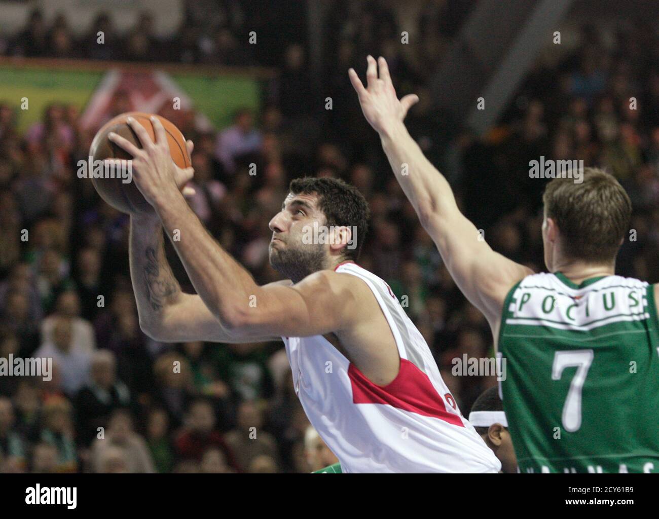 Ioannis Bourousis of Olympiacos (L) goes for basket past Martynas Pocius of  Zalgiris during their Euroleague