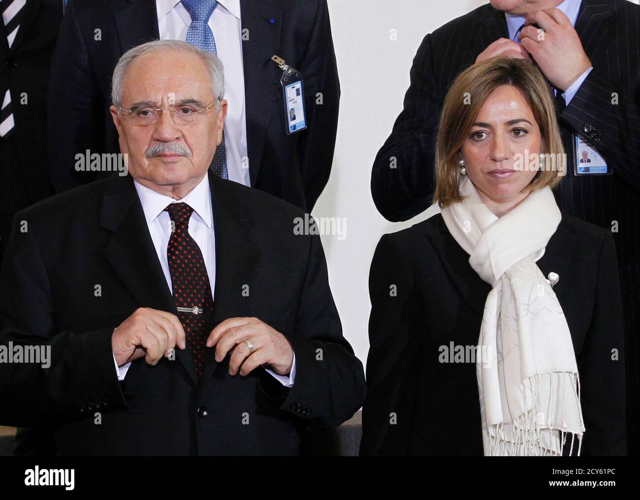 Defence ministers Mehmet Vecdi Gonul (L) of Turkey and Carme Chacon of Spain pose for a family photo following a NATO defence ministers meeting at the Alliance headquarters in Brussels March 10, 2011. NATO defence ministers meeting in Brussels on Thursday and Friday will discuss options to respond to the turmoil in Libya, including a possible no-fly zone, the officials said.    REUTERS/Thierry Roge   (BELGIUM - Tags: MILITARY POLITICS) Stock Photo
