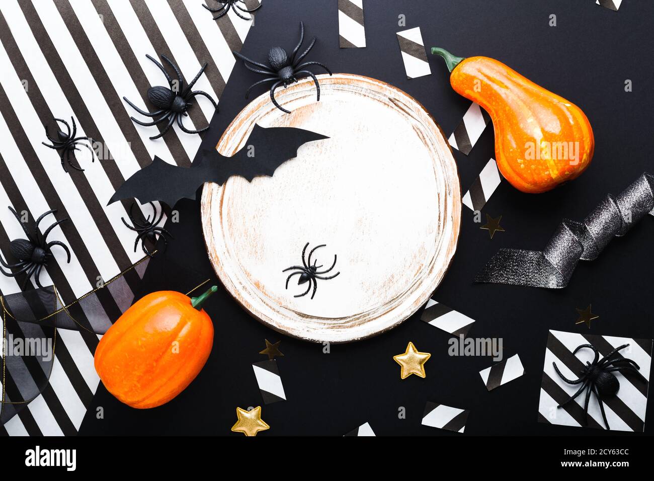 Halloween party invitation mockup, celebration. Halloween decorations concept with bats, spiders, pumpkins, stars, confetti, ribbon. Flat lay, top Stock Photo