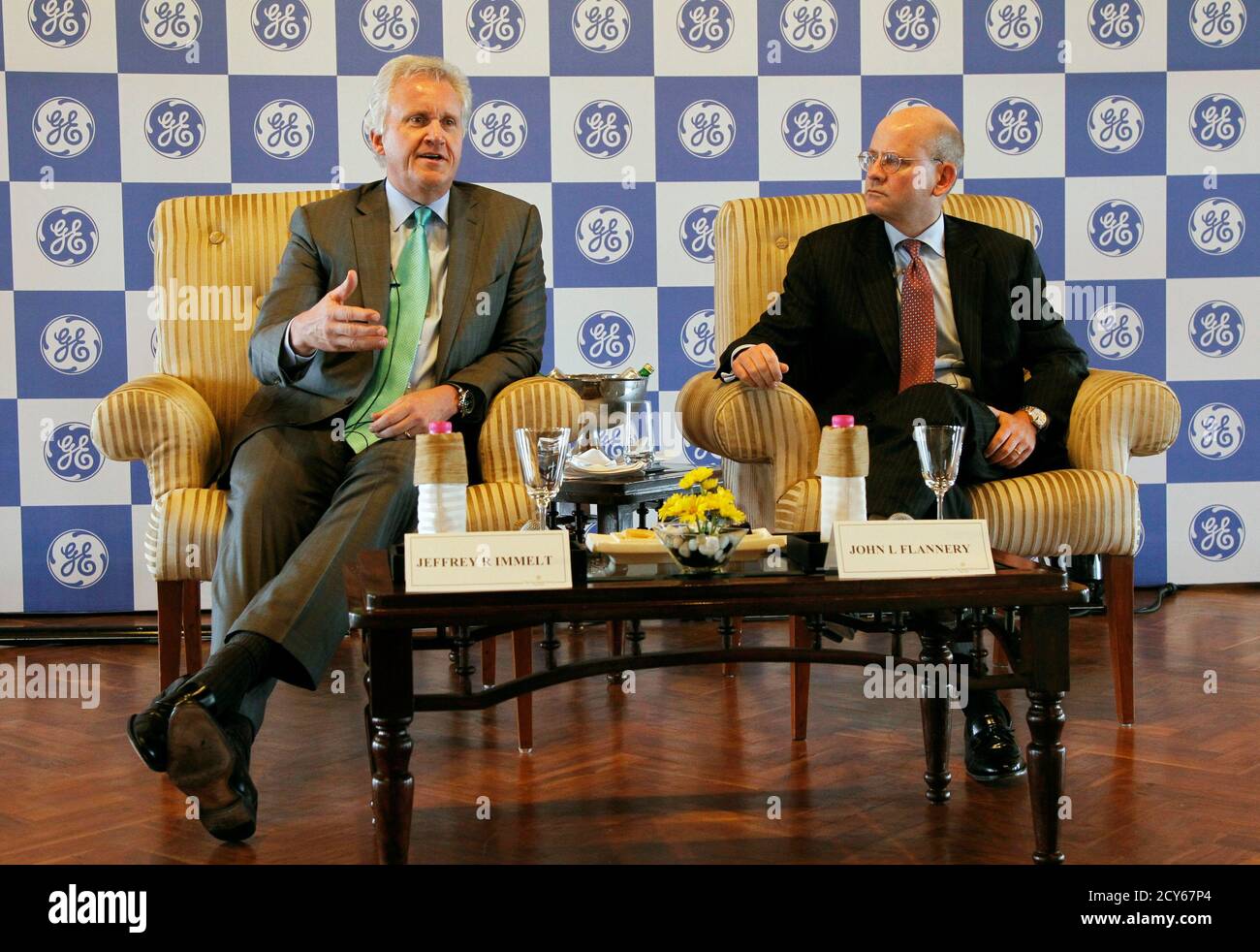General Electric Co Chief Executive Jeff Immelt (L) speaks with the media as John Flannery, head of GE in India, watches in New Delhi February 22, 2013. General Electric Co expects revenues from the company's Indian business to grow between 15 and 20 percent on a "sustainable basis", Immelt said on Friday. GE, which installed India's first hydro power plant in 1902, has Indian revenues of about $2.8 billion and employs about 15,000 people there. REUTERS/B Mathur (INDIA - Tags: BUSINESS ENERGY) Stock Photo