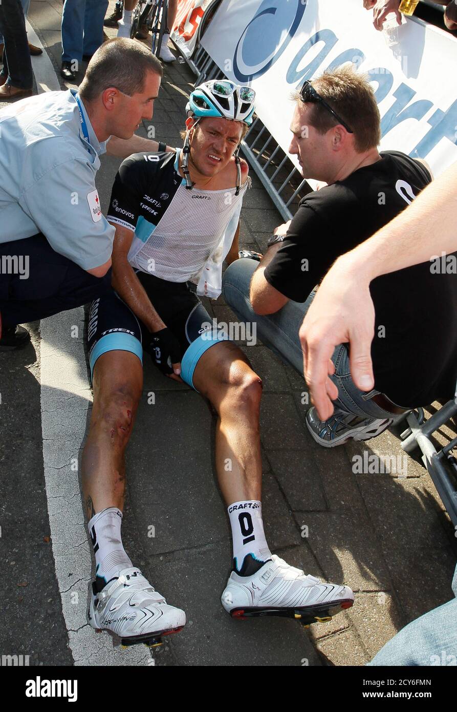Leopard Trek rider Wouter Weylandt of Belgium is assisted by rescuers after crashing a few kilometres before the finishing line of the 99th Scheldeprijs/Grand Prix de l'Escaut cycling race in Schoten April 6, 2011. Weyland has been transported to the hospital, organisers of the race said. REUTERS/Yves Herman (BELGIUM - Tags: SPORT CYCLING) Stock Photo