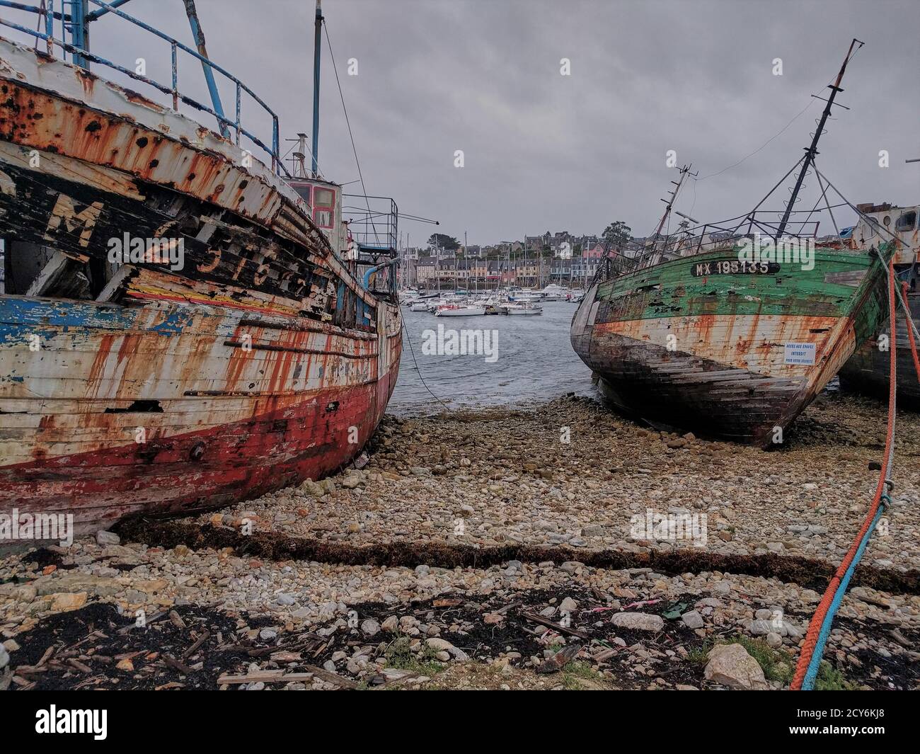 Old shipwrecks stranded in a harbor in Brittany, France. Stock Photo