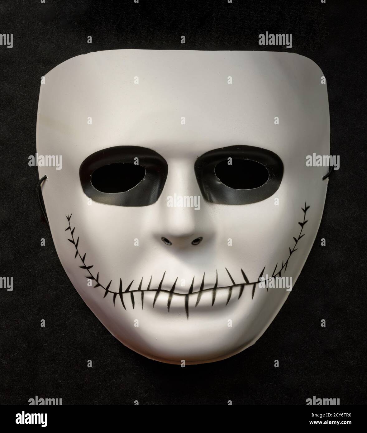 White Skeleton Face Mask Isolated Against Black Background Stock Photo