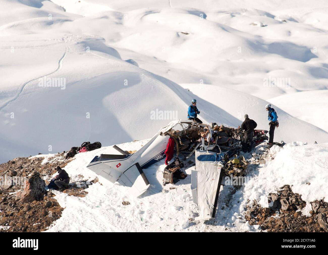 Rescuers work on the wreckage of a Beechcraft plane after a crash near the  Weisshorn in the Val d'Anniviers region February 11, 2011. The aircraft  disappeared from radar screen at 12:45 local