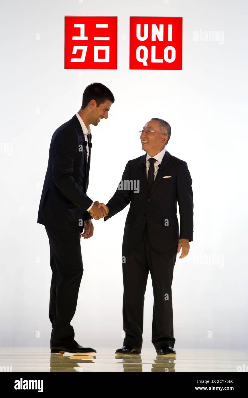 Tennis player Novak Djokovic of Serbia (L) shakes hands withTadashi Yanai,  chairman and chief executive of Fast Retailing Co, as they attend the  presentation of a new sponsorship deal with Uniqlo budget