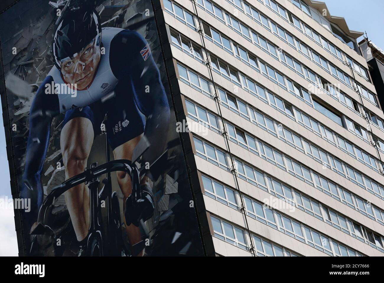 A giant poster of British cyclist Chris Hoy hangs on the side of a tower block in Stratford, London July 25, 2012.  REUTERS/Phil Noble (BRITAIN - Tags: SPORT CYCLING OLYMPICS CITYSPACE) Stock Photo