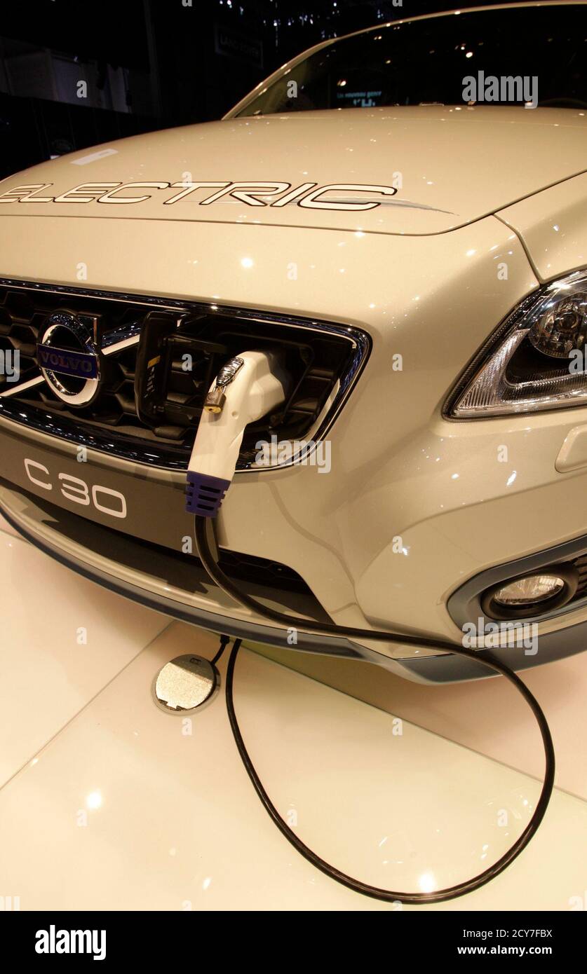 A new Volvo C30 hybrid car is being charged during the first media day of  the 81st Geneva International Motor Show at the Palexpo in Geneva March 1,  2011. REUTERS/Denis Balibouse (SWITZERLAND -