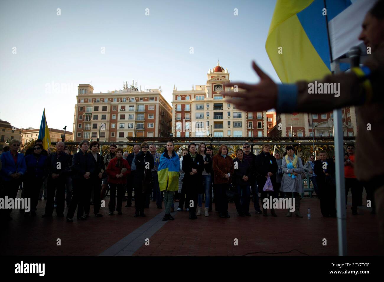 Ukrainians living in Malaga stand while a compatriot (R) talks to them during a protest against Russian President Vladimir Putin and in favor of unity and democratic freedom in Ukraine, in downtown Malaga, southern Spain, March 16, 2014. France on Sunday demanded Russia immediately take measures to reduce 'pointless and dangerous' tensions in Ukraine, calling the secession referendum held in the Crimea region illegal. REUTERS/Jon Nazca (SPAIN - Tags: POLITICS CIVIL UNREST ELECTIONS) Stock Photo