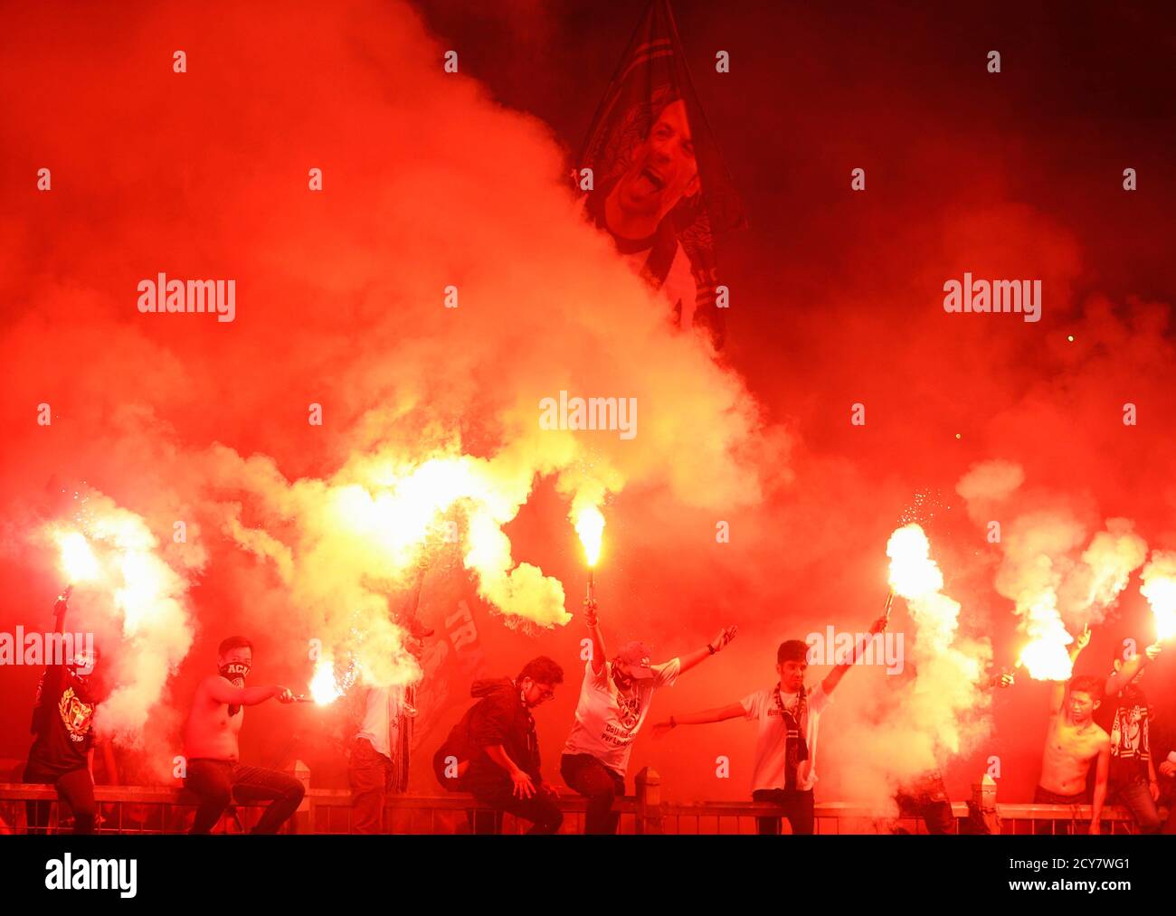 Juventus supporters light flares during their friendly soccer match against  Indonesia Super League (ISL) All-Stars in Jakarta, August 6, 2014. Juventus  Football Club is holding a three-day visit in Indonesia as a