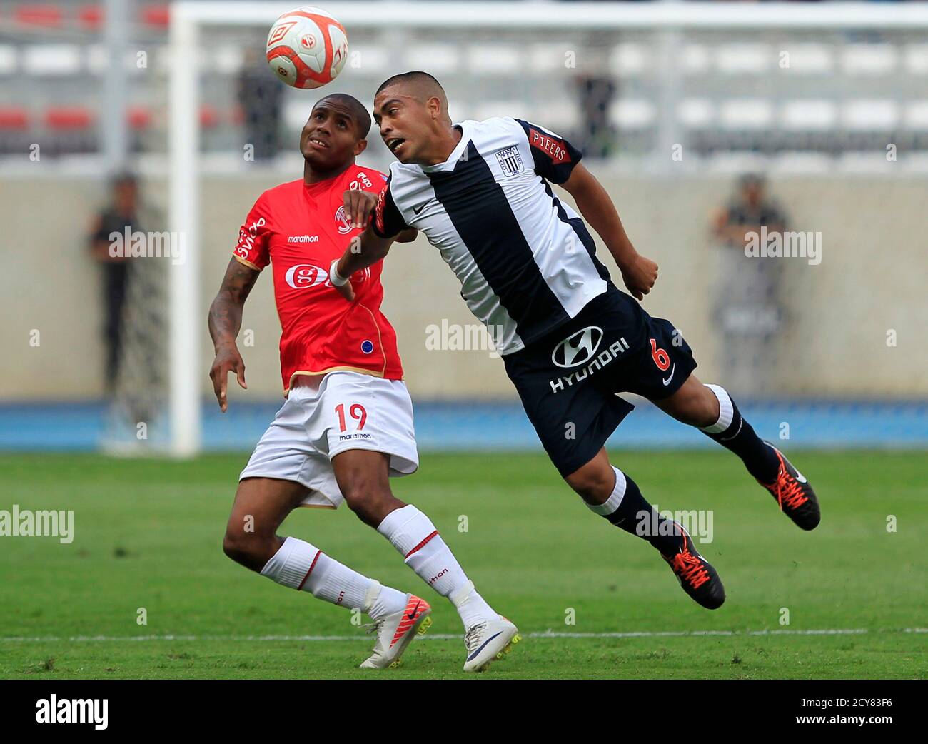 Alianza Lima's Junior Viza (R) battles for the ball with Juan Aurich's  Roberto Guizasola during the third final of the Peruvian soccer  championship, at the National Stadium in Lima December 14, 2011.