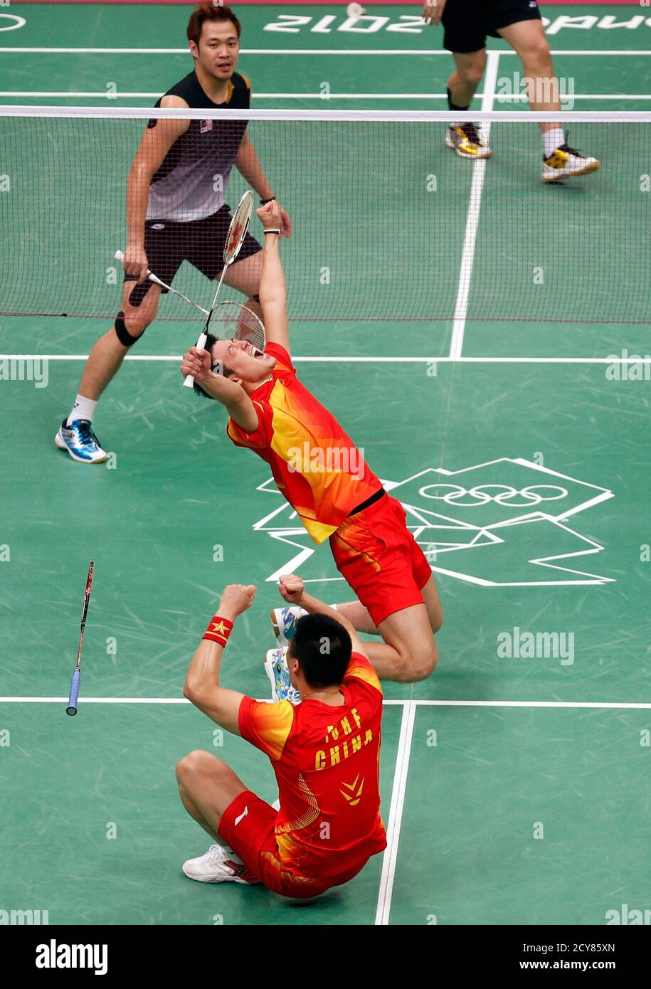 China's Cai Yun and his teammate Fu Haifeng (bottom) celebrate winning  their men's doubles badminton semifinal match against Malaysia's Koo Kien  Keat (top L) and Tan Boon Heong at the London 2012