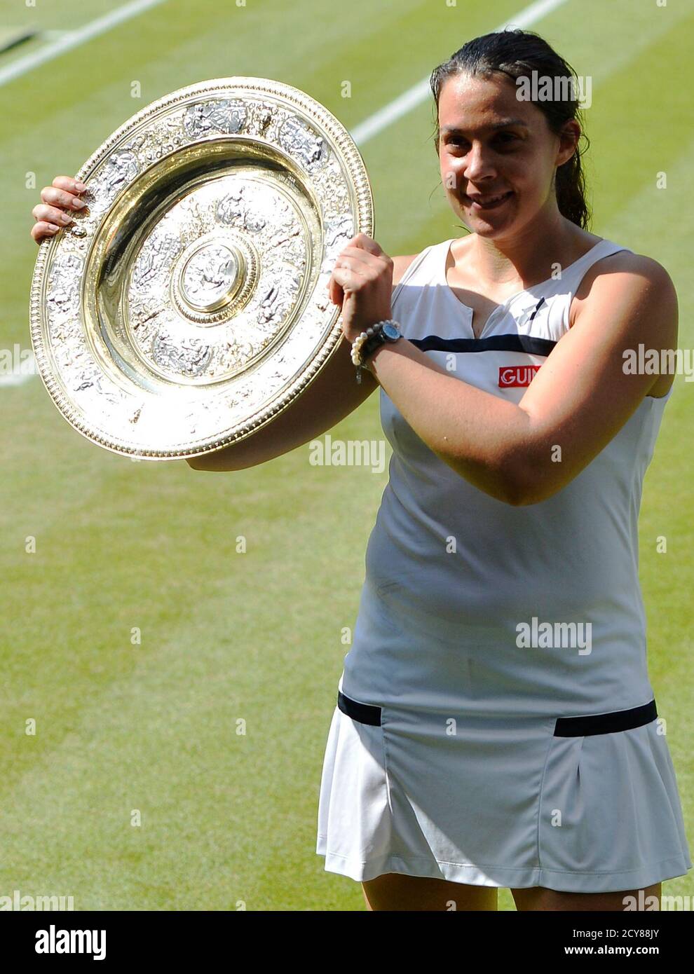 Marion Bartoli Of France Holds Her Winners Trophy The Venus Rosewater Dish After Defeating Sabine Lisicki Of Germany In Their Women S Singles Final Tennis Match At The Wimbledon Tennis Championships In London