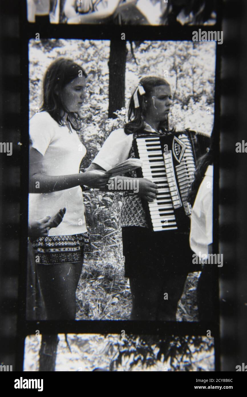 Fine 1970s vintage black and white photography of a young girl playing the accordion. Stock Photo