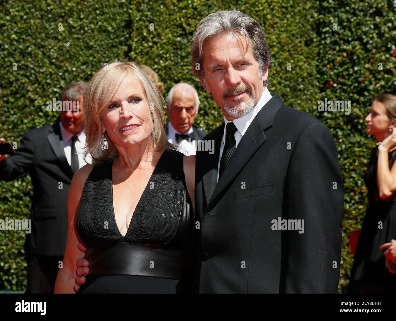 Actor Gary Cole (R) and wife actress Teddi Siddall (L) pose at the 2014 Creative Arts Emmy Awards in Los Angeles, California August 16, 2014.  REUTERS/Danny Moloshok  (UNITED STATES-Tags: ENTERTAINMENT) Stock Photo
