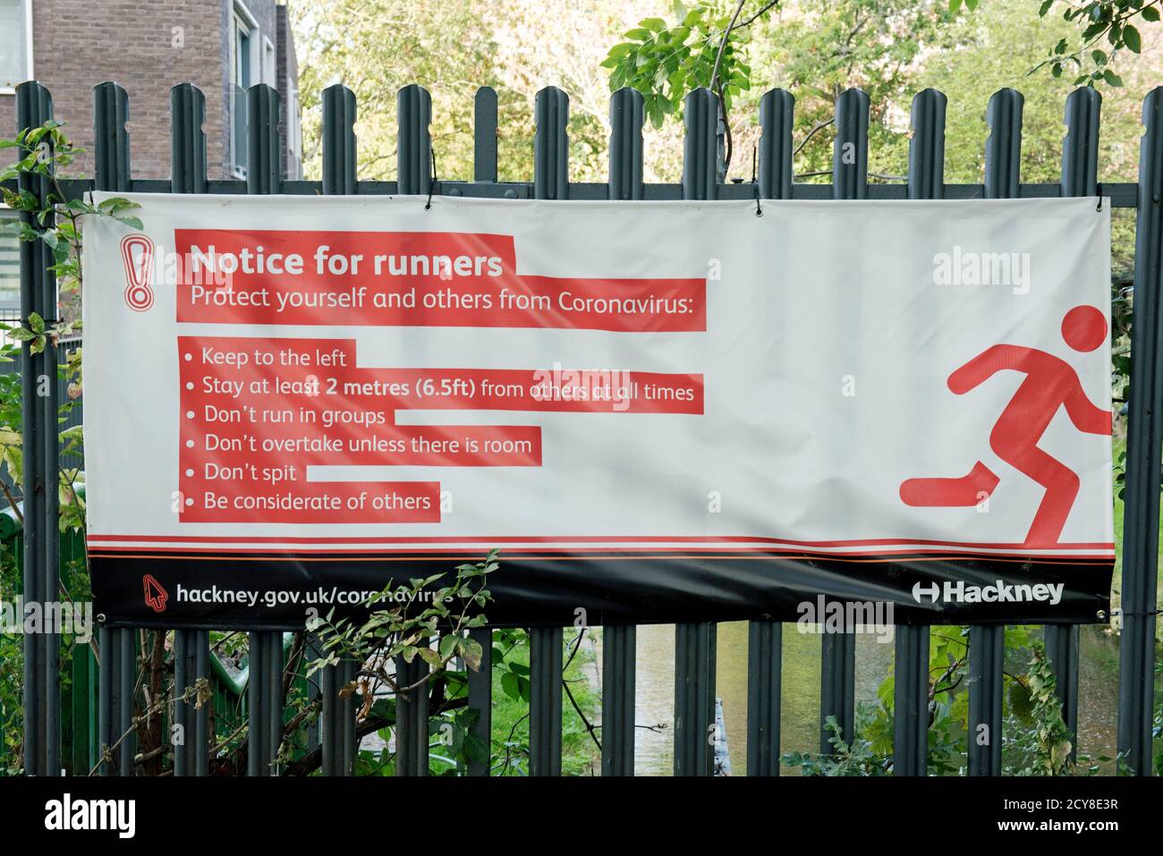 Notice for Runners sign or banner advising runners on protecting themself and others from Coronavirus Covid19, Woodberry Wetlands Stoke Newington London Stock Photo