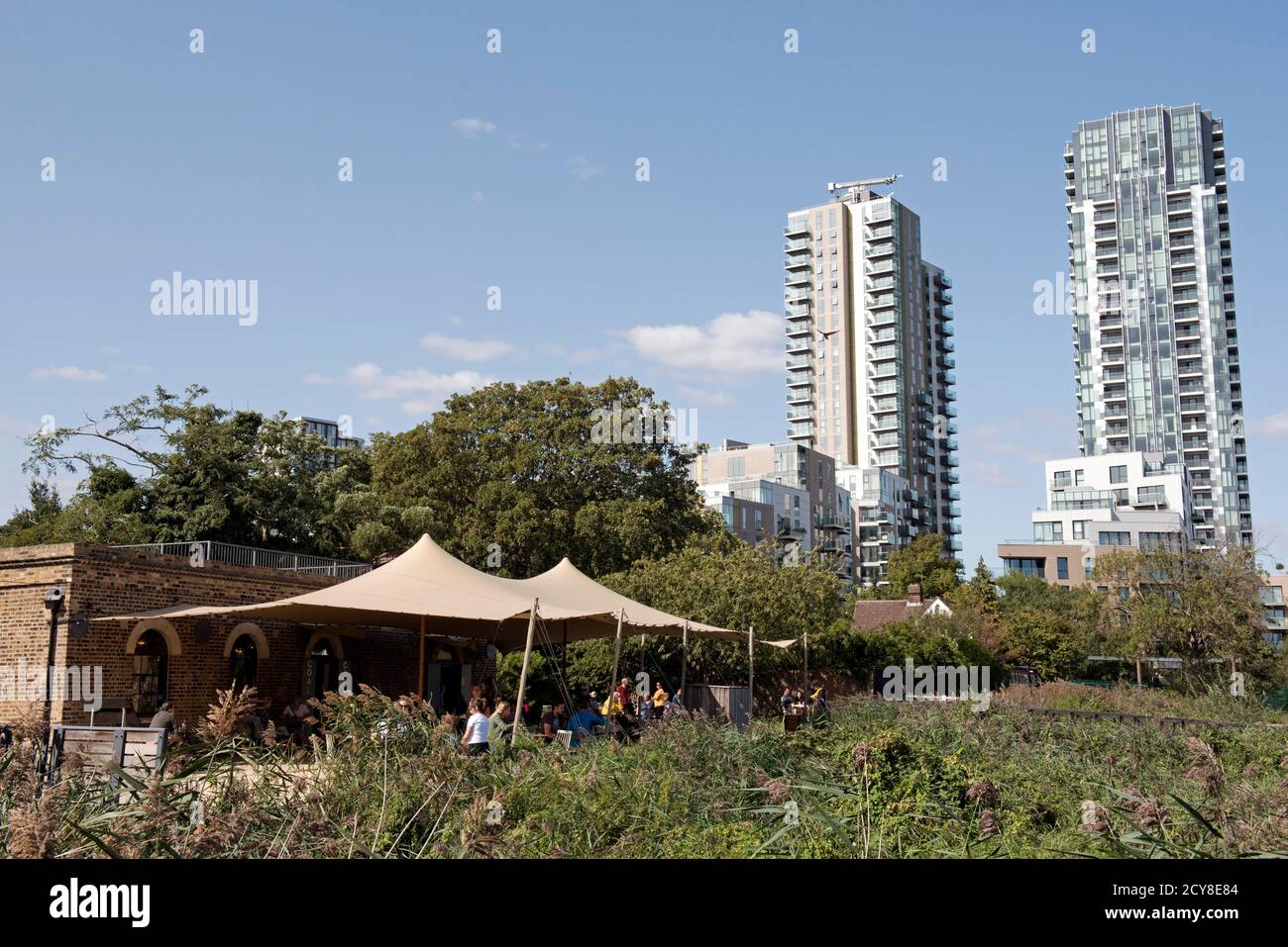 The Coal House cafe resturant with people in front and tower blocks to