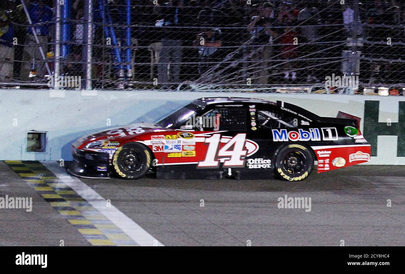 Tony Stewart crosses the finish line in his number 14 Chevrolet to win the  Ford 400 NASCAR Sprint Cup race at the Homestead-Miami Speedway in  Homestead, Florida, November 20, 2011. Stewart was