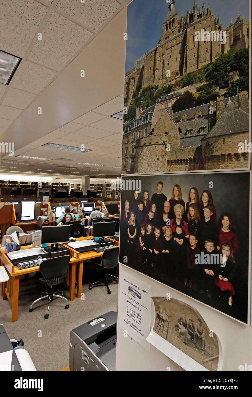 Pictures of families and historical places hang on a wall as people research records to work on their genealogy in the Family History Library of The Church of Jesus Christ of Latter-Day Saints on the campus of Brigham Young University (BYU) in Provo February 16, 2012. REUTERS/George Frey  (UNITED STATES - Tags: EDUCATION RELIGION) Stock Photo