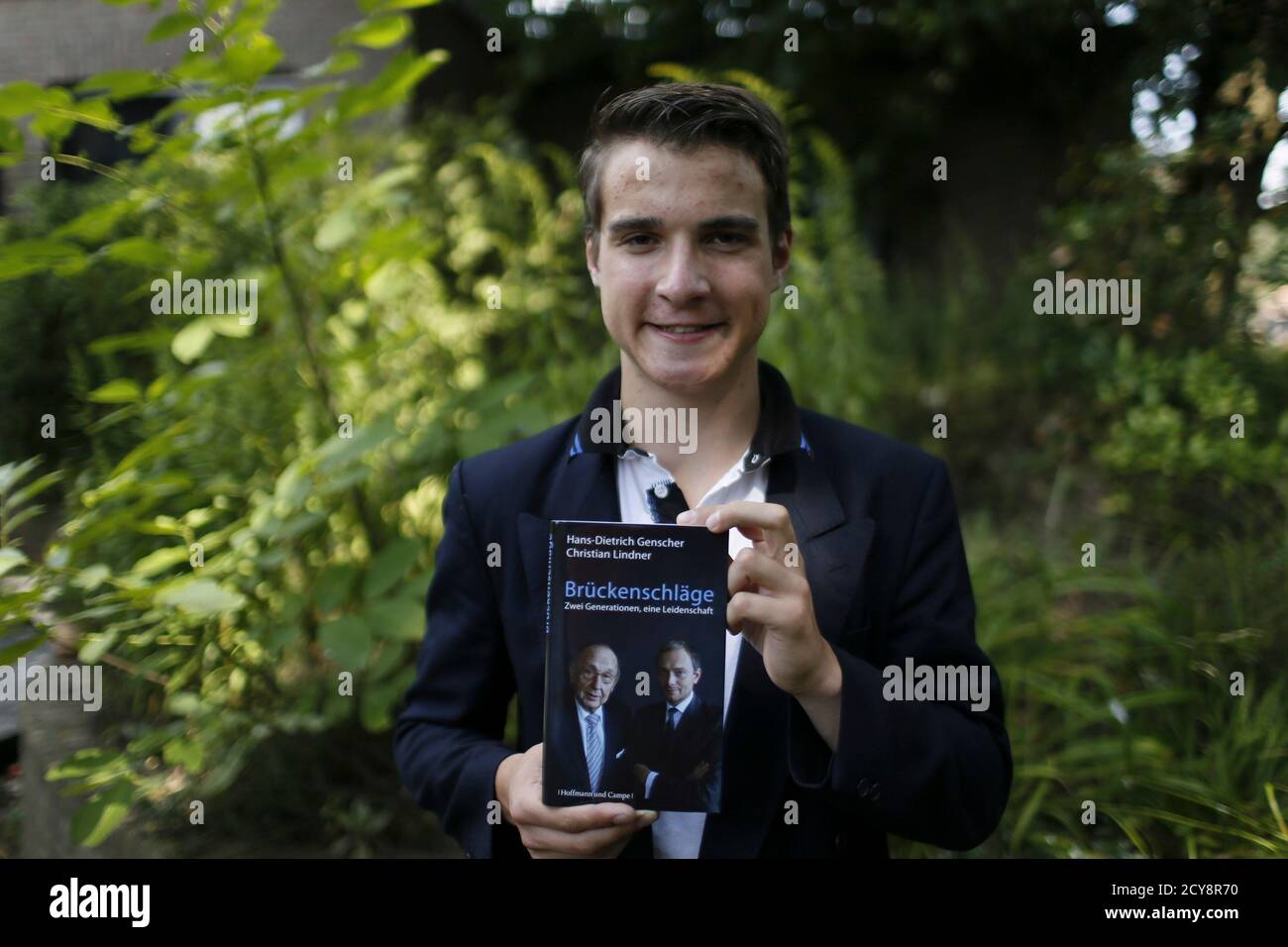 Linus Stieldorf, a member of Germany's Free Democratic party (FDP) in  Heinsberg and candidate for the upcoming general election, poses with a  book of his FDP idols former German Foreign minister Hans-Dietrich