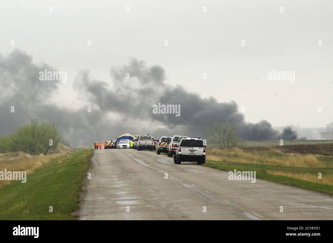 Smoke from the wreckage of several oil tanker cars that derailed in a field near the town of Heimdal, North Dakota May 6, 2015.  A train carrying crude oil derailed and caught fire on Wednesday, officials said, just days after the U.S. government announced sweeping reforms to improve safety of the volatile shipments.  REUTERS/Andrew Cullen Stock Photo