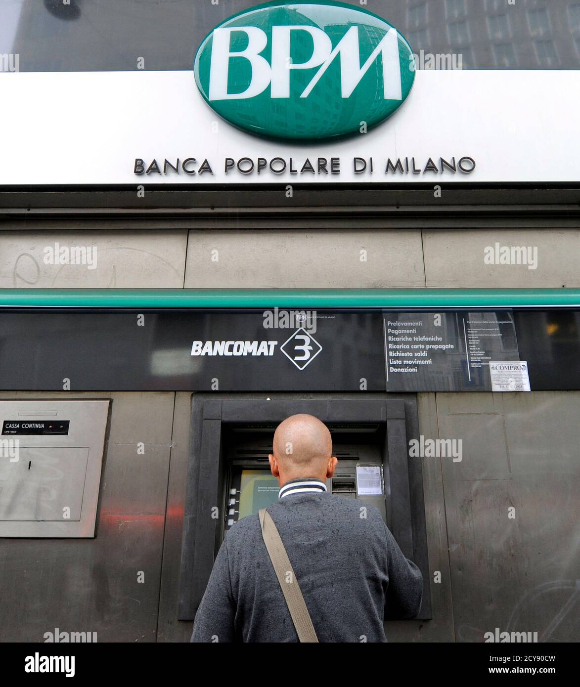 A Customer Uses A Cash Machine At The Banca Popolare Di Milano In Milan October 25 2010 Reuters Paolo Bona Italy Tags Business Stock Photo Alamy
