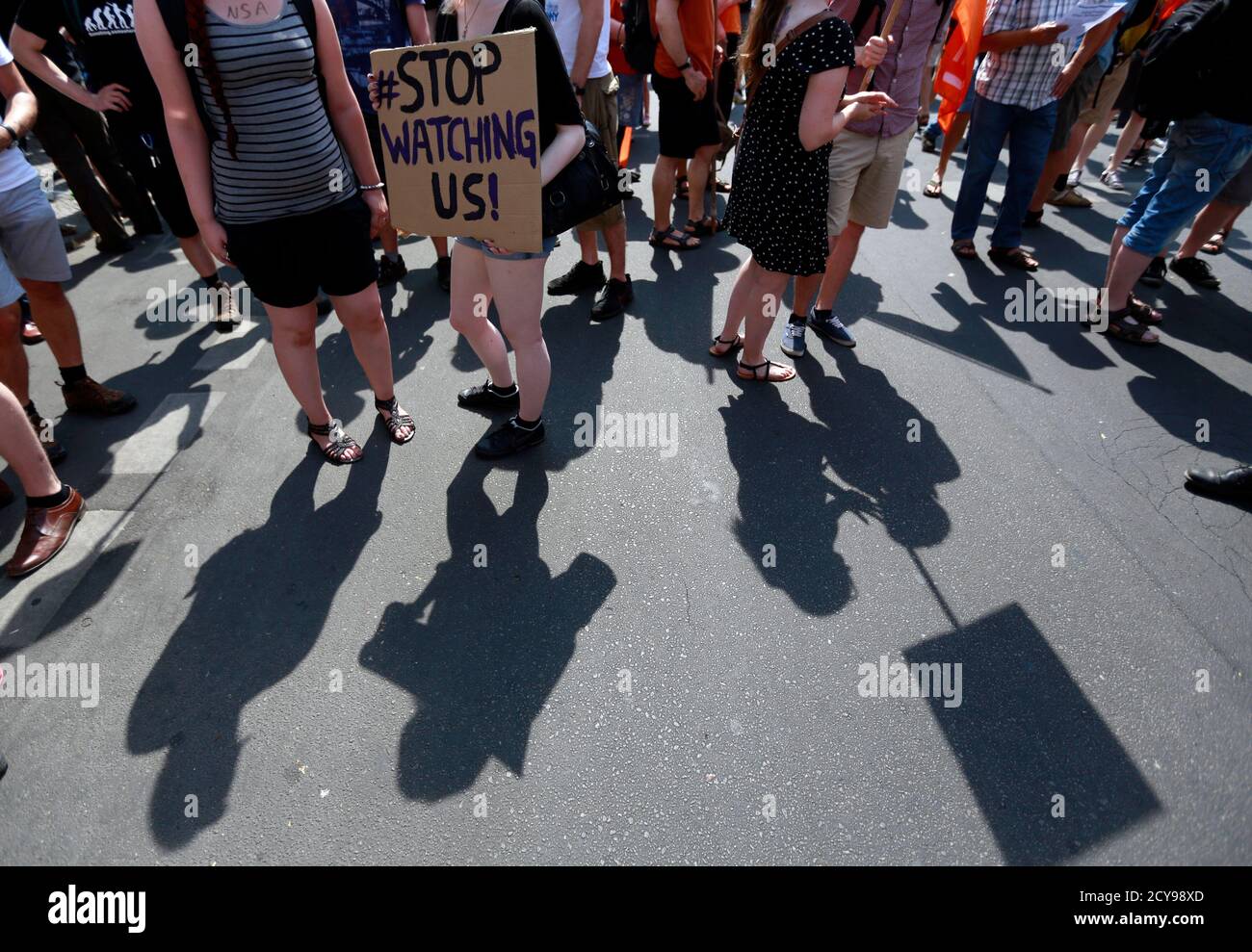 Protesters cast their shadows during a demonstration against secret monitoring programmes PRISM, TEMPORA, INDECT and showing solidarity with whistleblowers Edward Snowden, Bradley Manning and others in Berlin July 27, 2013. REUTERS/Pawel Kopczynski (GERMANY  - Tags: CIVIL UNREST) Stock Photo