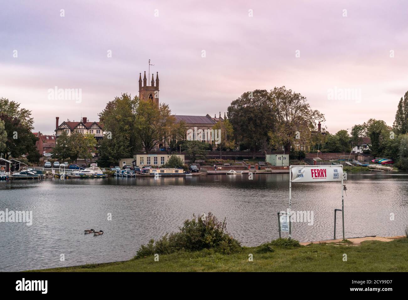Sunset over the Thames river with Saint Mary's Parish Church in Hampton, West London, England, UK Stock Photo