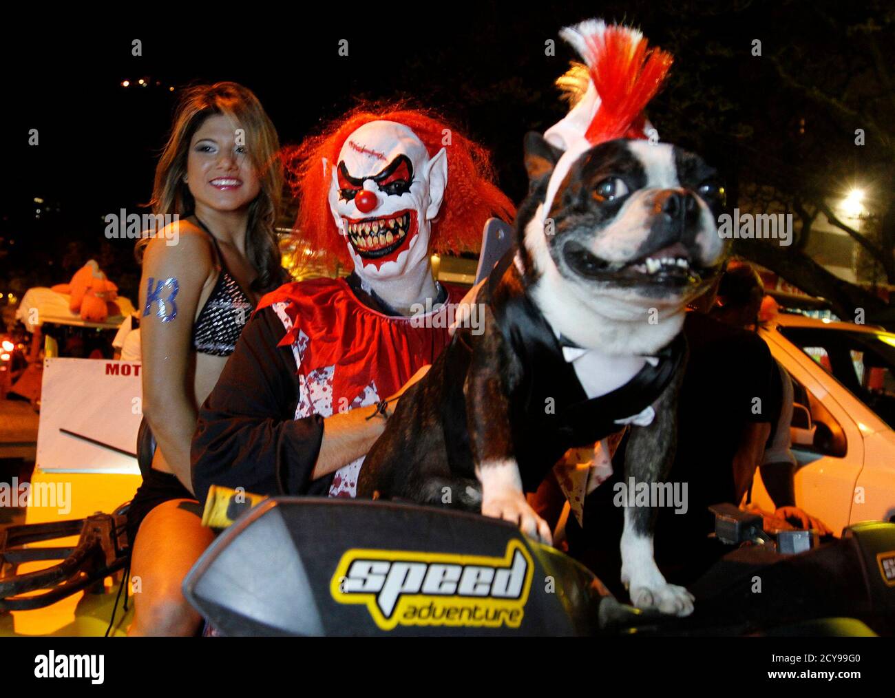 A couple dressed in costume rides a vehicle during the "Moto Halloween  Party 2013" in Cali October 30, 2013. Every year, motorcycling enthusiasts  dress up in outfits and ride around Cali to