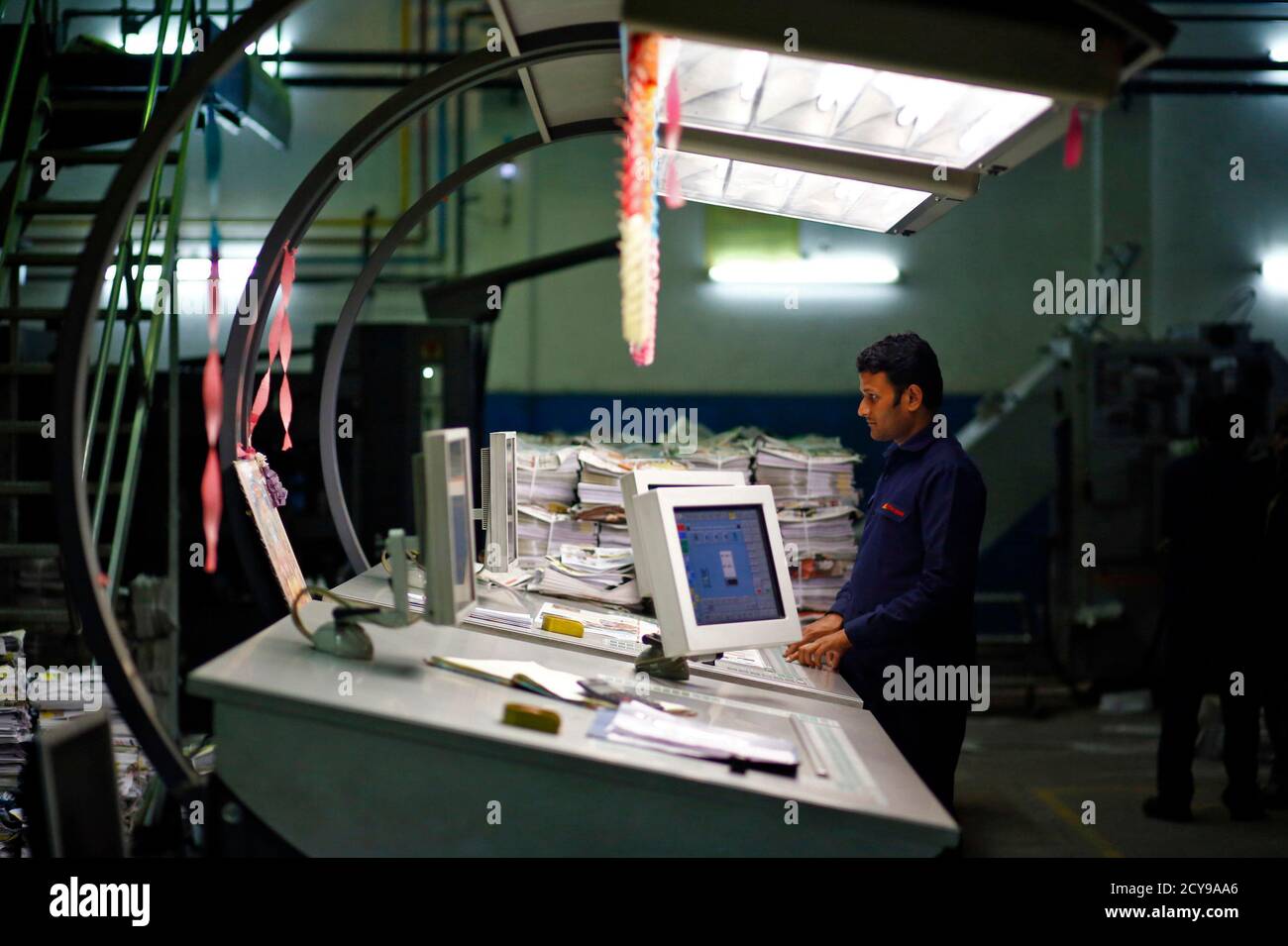 An Employee Works On A Computer Inside Dainik Jagran Printing Press In Noida On The Outskirts Business news in hindi (बिजनेस समाचार): alamy