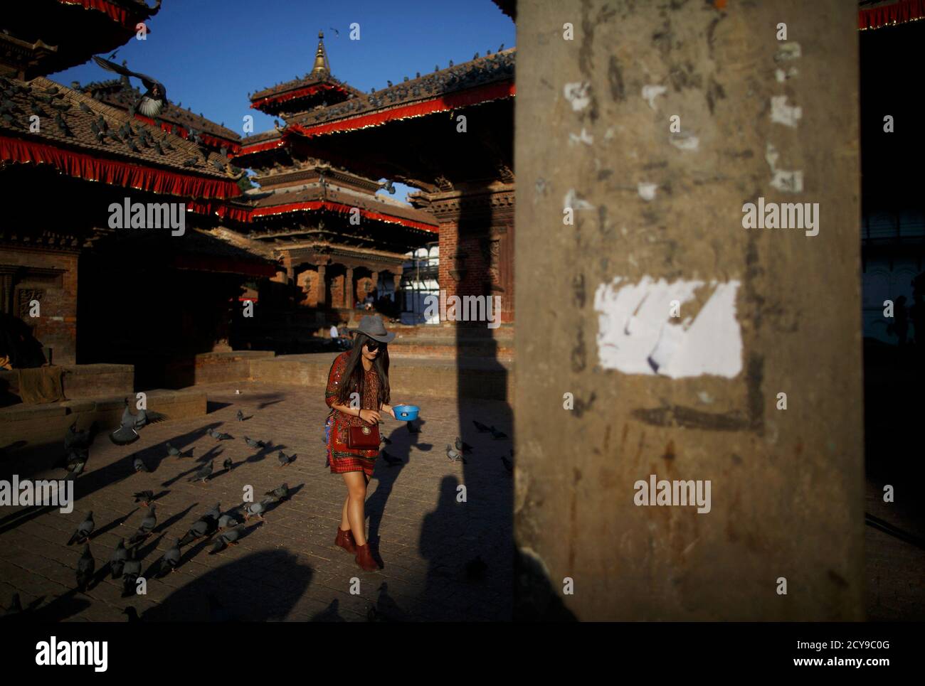 A Tourist Feeds Pigeons At Bashantapur Durbar Square In Kathmandu October 22 14 Reuters Navesh Chitrakar Nepal s Society Travel Stock Photo Alamy