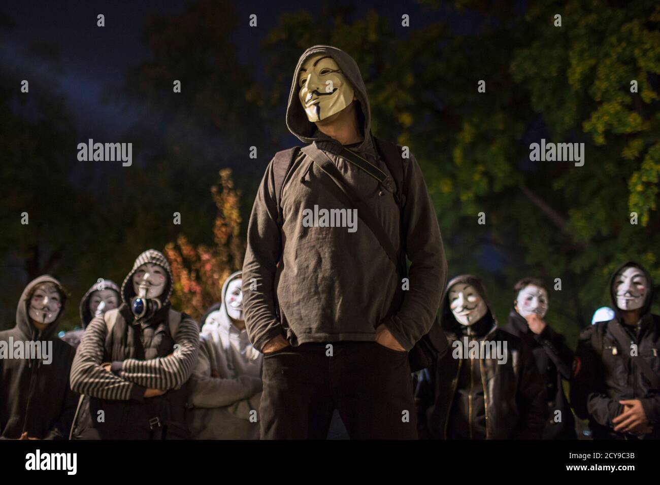 Protesters wearing Guy Fawkes masks stand in a park in downtown Belgrade November 5, 2014, on the day marking Guy Fawkes Night. REUTERS/Marko Djurica (SERBIA - Tags: SOCIETY POLITICS ANNIVERSARY CIVIL UNREST TPX IMAGES OF THE DAY) Stock Photo